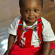 Omari joined the competition — help win amazing prizes! toddler, child, baby, smiling, sitting, indoors, clothing, red_suspender, bow_tie, white_shirt, number_one, colorful, floor, wooden_floor, portrait, cute, happy, person, face, young_child