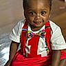 toddler, child, baby, smiling, sitting, indoors, clothing, red_suspender, bow_tie, white_shirt, number_one, colorful, floor, wooden_floor, portrait, cute, happy, person, face, young_child