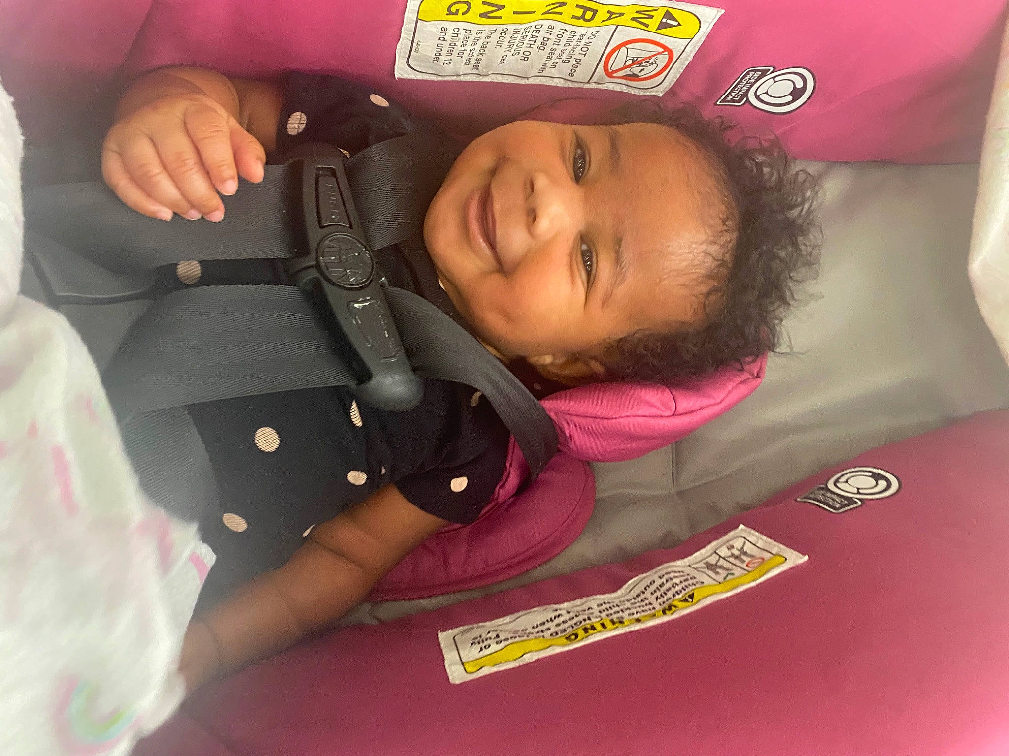 Jnylah is registered to the contest to win money with this photo: auto_part, baby, baby_products, baby_toddler_clothing, car_seat, carmine, child, comfort, finger, fun, gesture, happy, joy, magenta, nail, person, pink, room, skin, smile