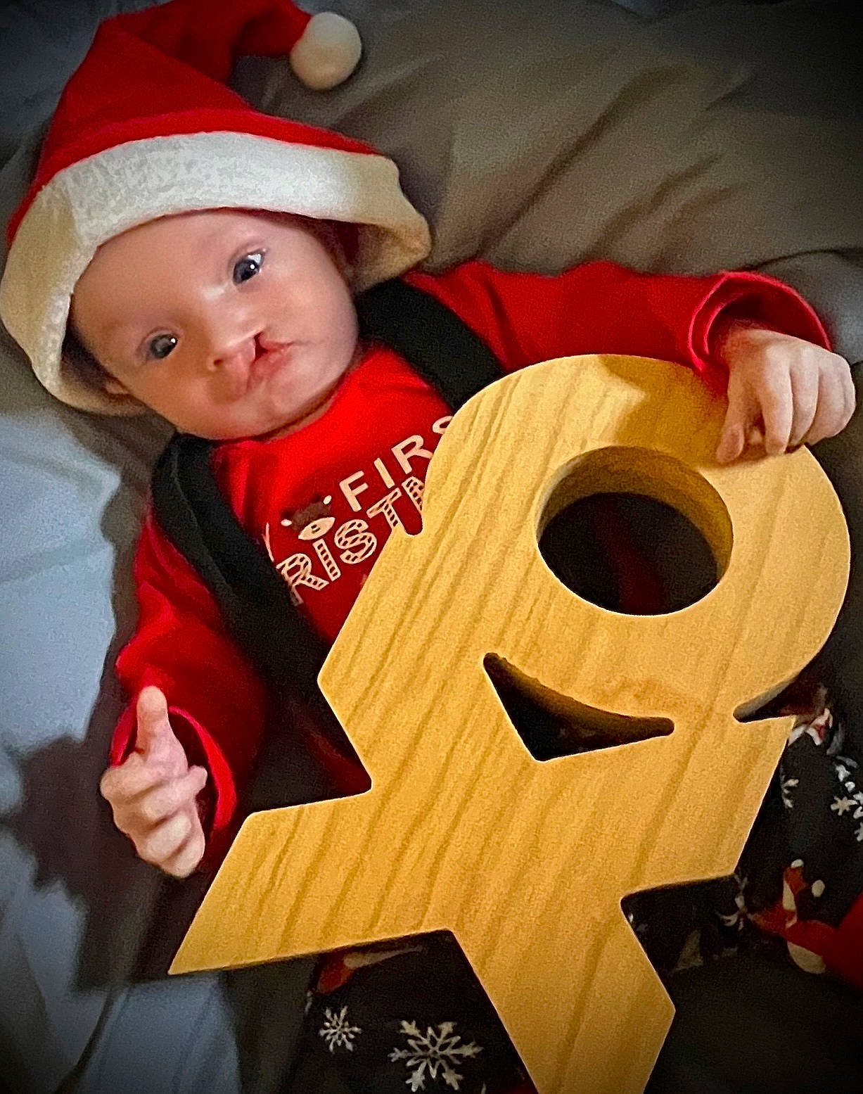 Braxton is registered to the contest to win money with this photo: baby, baby_toddler_clothing, cap, carmine, child, christmas, christmas_eve, costume, costume_hat, event, fictional_character, fun, happy, hat, headgear, headwear, holiday, person, smile, toddler