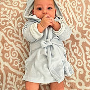 Kaya joined the competition — help win amazing prizes! baby, infant, child, bathrobe, blanket, lying_down, hands, face, eyes, cute, cozy, pattern, soft_texture, adorable, skin, portrait, indoor, young, comfort, expression