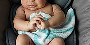 Kaya is registered to the contest to win money with this photo: baby, infant, towel, diaper, baby_chair, cushion, gray, skin, cute, expression, hand, foot, legs, indoors, child, seat, comfort, soft, person, newborn