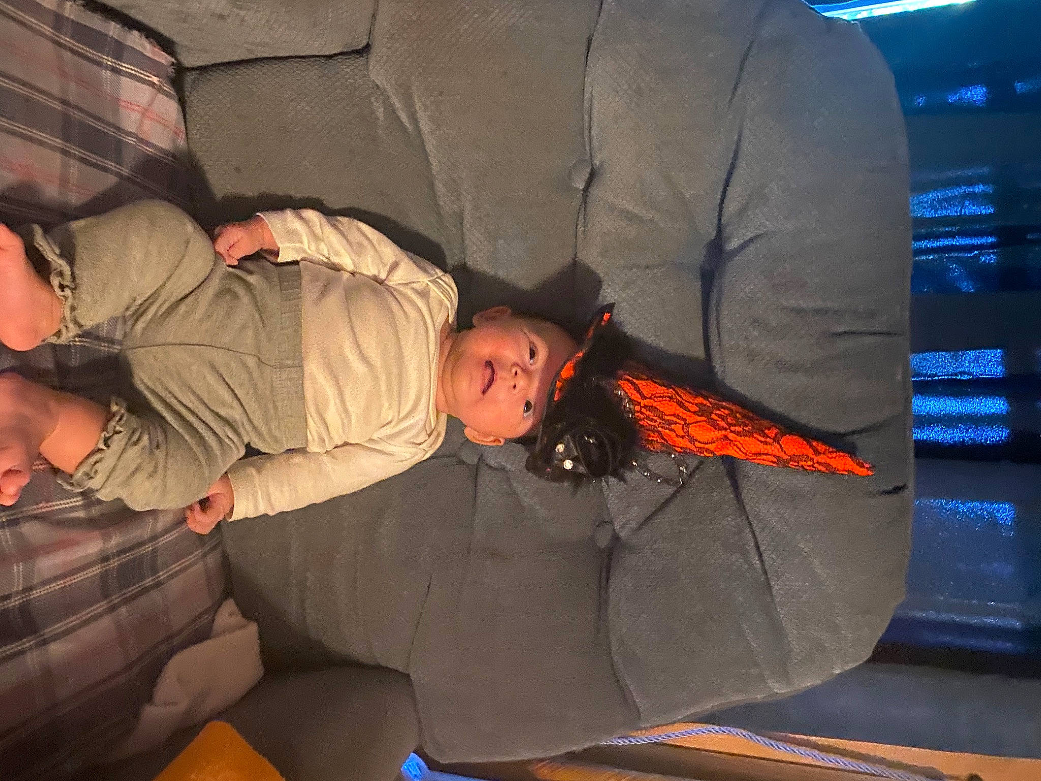 Freyja is registered to the contest to win money with this photo: bag, baggage, child, comfort, flooring, fun, human_leg, knee, lap, luggage_and_bags, luxury_vehicle, nap, orange, passenger, person, room, sitting, sleep, tints_and_shades, toddler