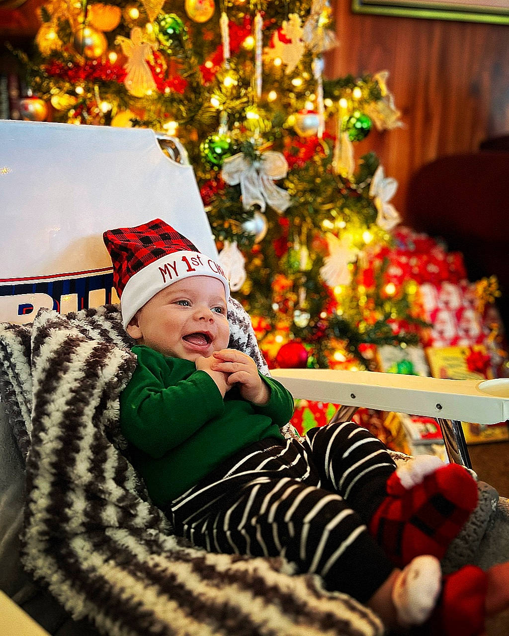 Damon joined the competition — help win amazing prizes! baby, baby_toddler_clothing, christmas, christmas_decoration, christmas_eve, christmas_ornament, christmas_tree, event, happy, hat, headwear, holiday, lap, ornament, person, plant, room, sleeve, smile, toddler