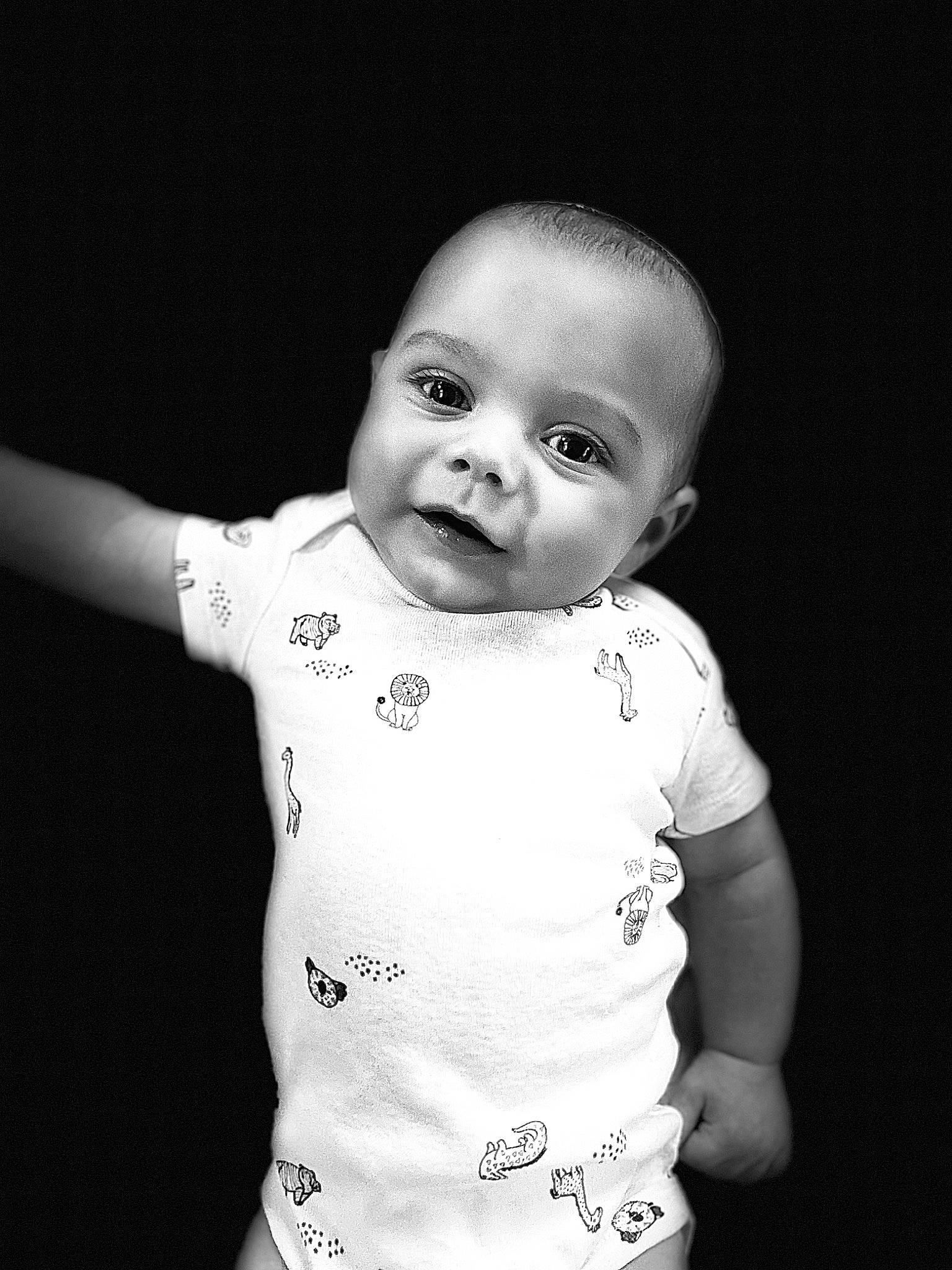 Damon is registered to the contest to win money with this photo: baby, baby_toddler_clothing, cheek, child, chin, eye, eyebrow, eyelash, flash_photography, gesture, happy, iris, lip, monochrome_photography, neck, one_piece_garment, person, skin, sleeve, smile