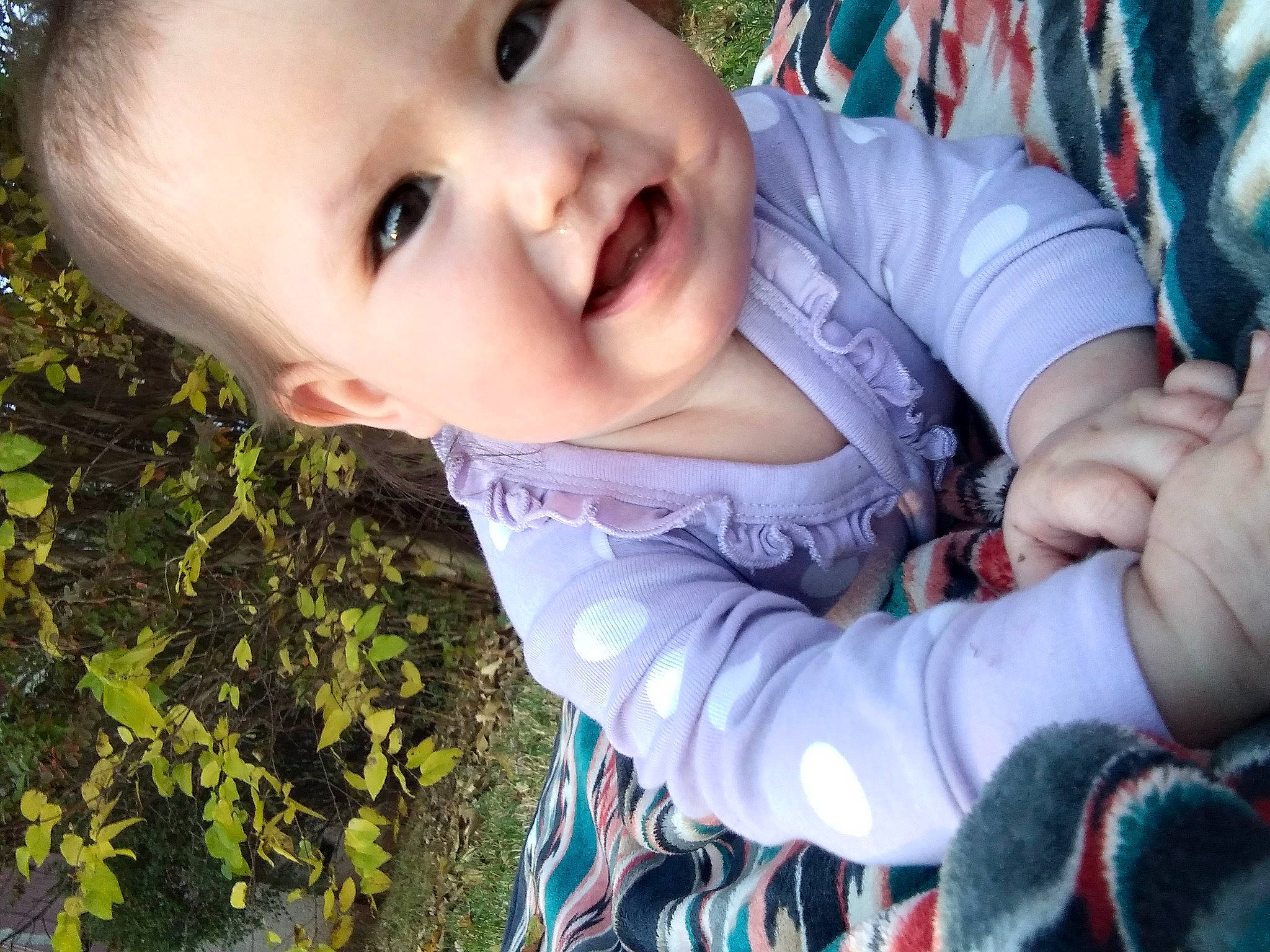 Leanna is registered to the contest to win money with this photo: baby, baby_toddler_clothing, blue, cheek, eye, face, facial_expression, finger, grass, happy, head, iris, lip, nose, people_in_nature, person, photograph, plant, skin, smile