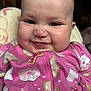 Kehlani joined the competition — help win amazing prizes! baby, child, face, smile, pink_onesie, donut_pattern, cookie_pattern, chubby_cheeks, finger, blanket, indoor, cute, infant, happy, portrait, head, eyes, mouth, clothing, person