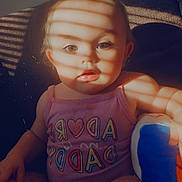 Maybrie is registered to the contest to win money with this photo: baby, child, infant, sitting, portrait, face, eyes, expression, pink_clothing, romper, toy, blue_toy, couch, indoor, window_light, sunlight, shadows, striped_shadows, close_up, photography