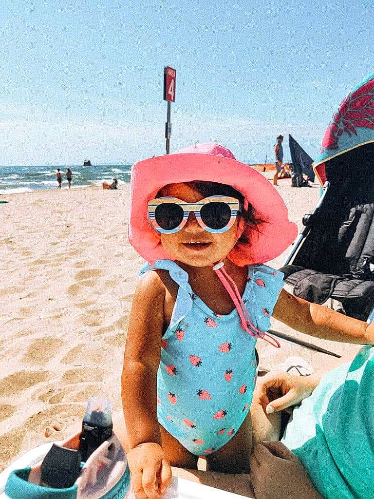 Mila joined the competition — help win amazing prizes! azure, beach, blue, body_of_water, cool, eyewear, fun, goggles, happy, hat, headwear, leisure, natural_environment, people_on_beach, person, sky, smile, summer, sunglasses, toddler