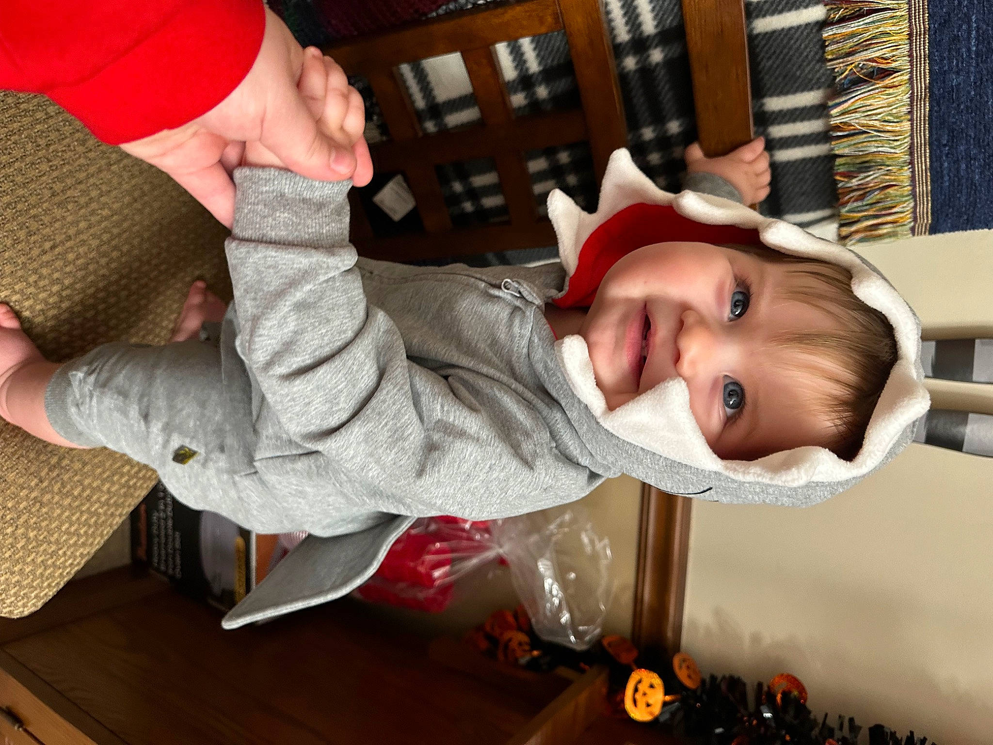 Rowan is registered to the contest to win money with this photo: baby, child, christmas, christmas_eve, event, facial_expression, fun, gesture, happy, hat, headgear, holiday, joy, lap, mouth, person, play, sitting, smile, sock
