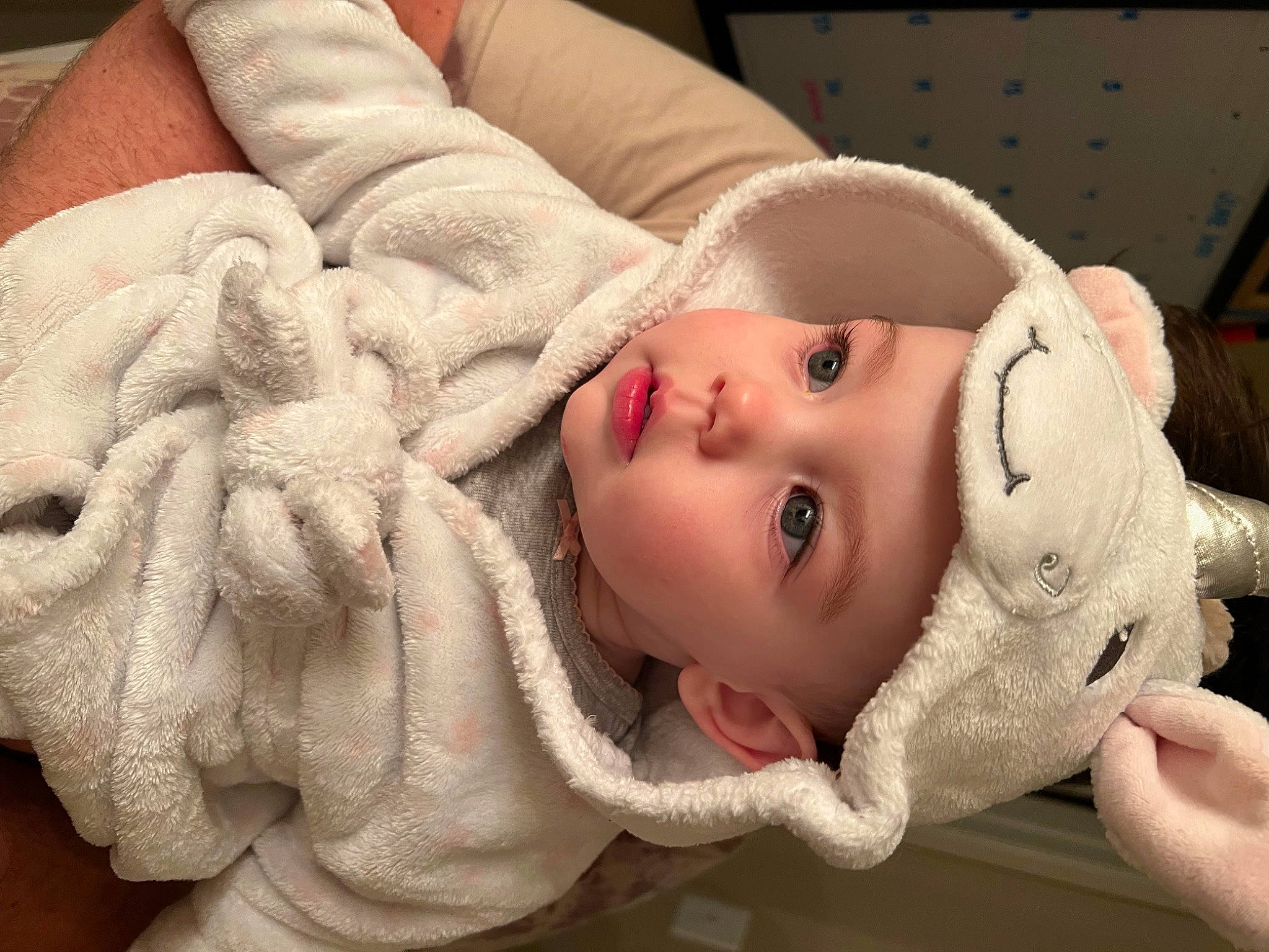 Ember is registered to the contest to win money with this photo: baby, cheek, chin, clothing, comfort, eye, eyebrow, face, facial_expression, hand, head, headwear, human_body, lip, mammal, mouth, nose, organ, person, skin