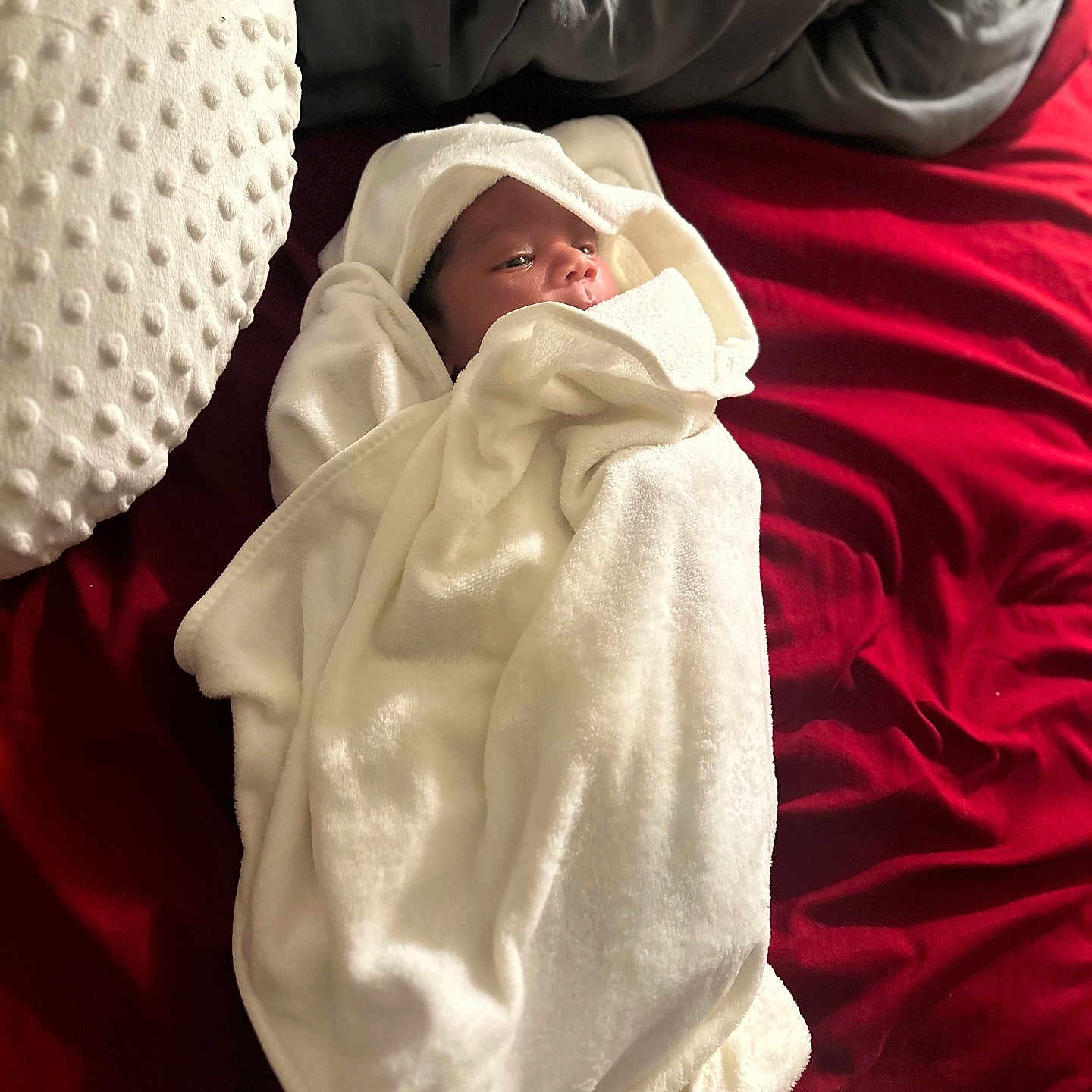 Kyantae is registered to the contest to win money with this photo: baby, bed, blanket, comfort, cozy, cute, face, gray_blanket, indoors, infant, lying_down, newborn, pillow, red_bedspread, resting, sleepwear, small, soft_texture, white_towel, wrapped