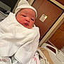 Khyla is registered to the contest to win money with this photo: newborn, baby, infant, blanket, white_cap, hospital_room, bed, wooden_door, footprints, wrapped, sleepy, person, indoor, cute, resting, newborn_baby, hospital_bed, soft, warm, cozy