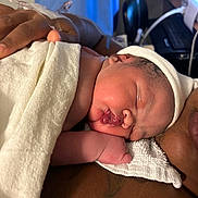 Khyla is registered to the contest to win money with this photo: newborn, baby, infant, sleeping, blanket, hat, skin, hand, hospital, adult, comfort, closeup, person, rest, care, medical, towel, indoors, family, love