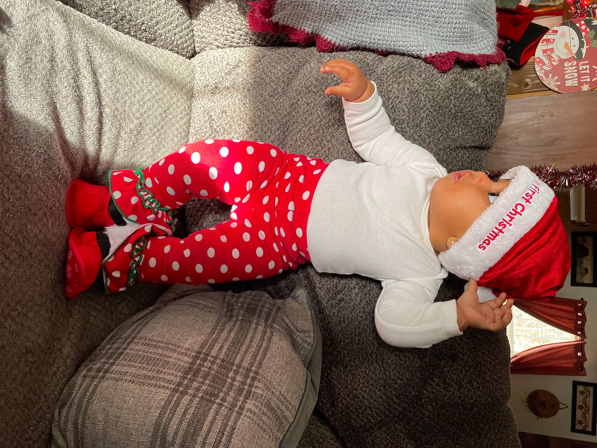 Arya joined the competition — help win amazing prizes! baby_toddler_clothing, carmine, comfort, elbow, foot, hat, headwear, human_leg, knee, lap, leg, linens, nail, pattern, person, plaid, sleeve, sock, t_shirt, tartan