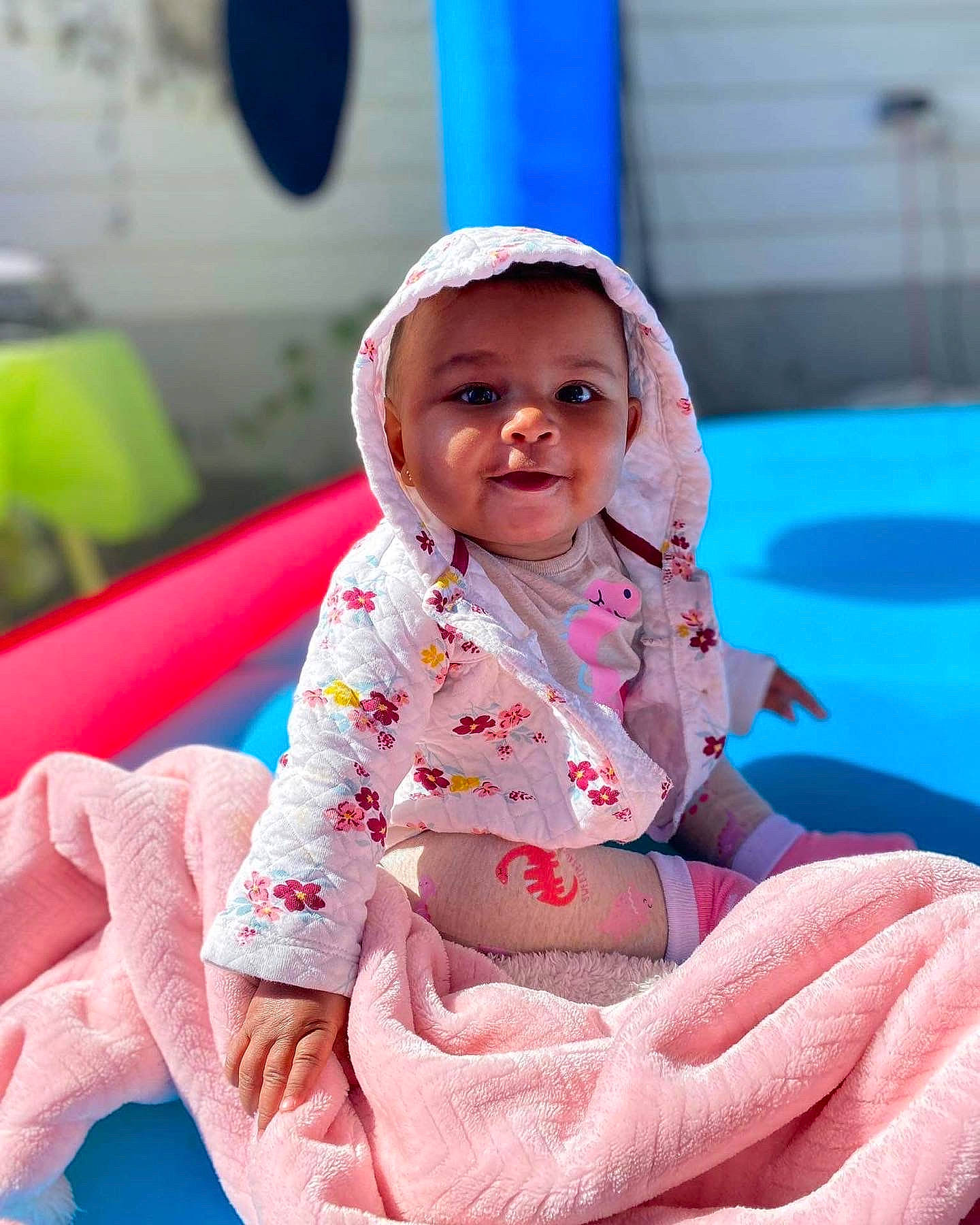Arya is registered to the contest to win money with this photo: baby, baby_products, baby_toddler_clothing, child, comfort, facial_expression, fun, happy, leisure, magenta, person, pink, play, portrait_photography, recreation, sitting, skin, sleeve, toddler, vacation