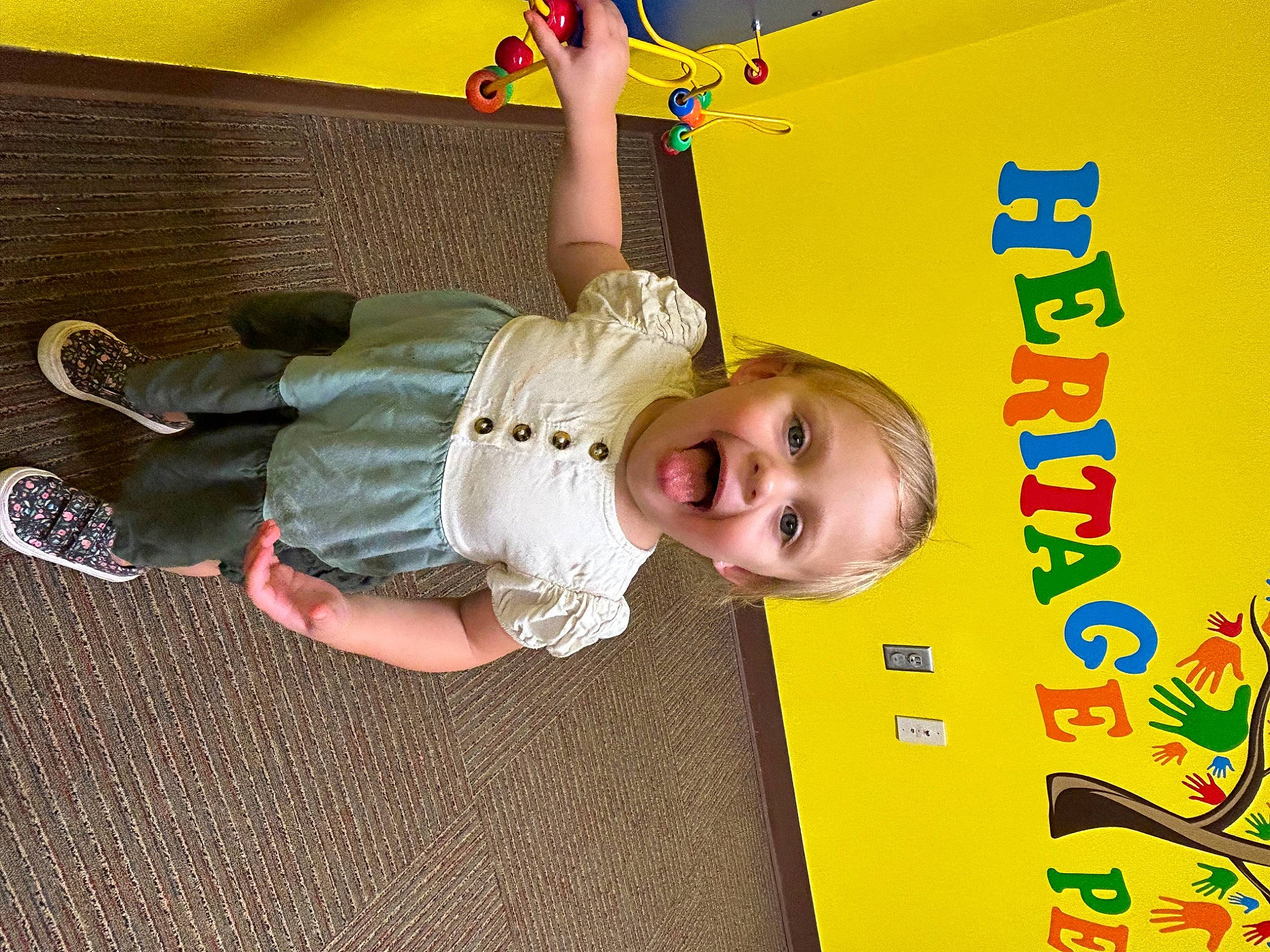 Brooklynn is registered to the contest to win money with this photo: baby, baby_toddler_clothing, child, flooring, fun, happy, leisure, person, play, room, smile, toddler, walking_shoe, wood