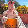 baby, child, halloween, orange_bucket, headband, bow, blanket, flowers, yellow_flowers, autumn, pumpkin, outdoor, grass, smiling, festive, holiday, costume, cute, seasonal, sunny