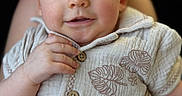 David joined the competition — help win amazing prizes! baby, child, infant, smile, face, hands, buttoned_shirt, leaf_pattern, cozy, portrait, closeup, blue_eyes, rosy_cheeks, cute, soft_light, skin, young_child, person, indoor, comfort