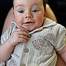 baby, child, infant, smile, face, hands, buttoned_shirt, leaf_pattern, cozy, portrait, closeup, blue_eyes, rosy_cheeks, cute, soft_light, skin, young_child, person, indoor, comfort
