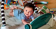 David joined the competition — help win amazing prizes! baby, child, play_mat, toys, indoor, floor, smile, blue_clothing, mirror, colorful, soft_toys, play_gym, wooden_floor, cute, infant, happy, crawling, home, person, toddler