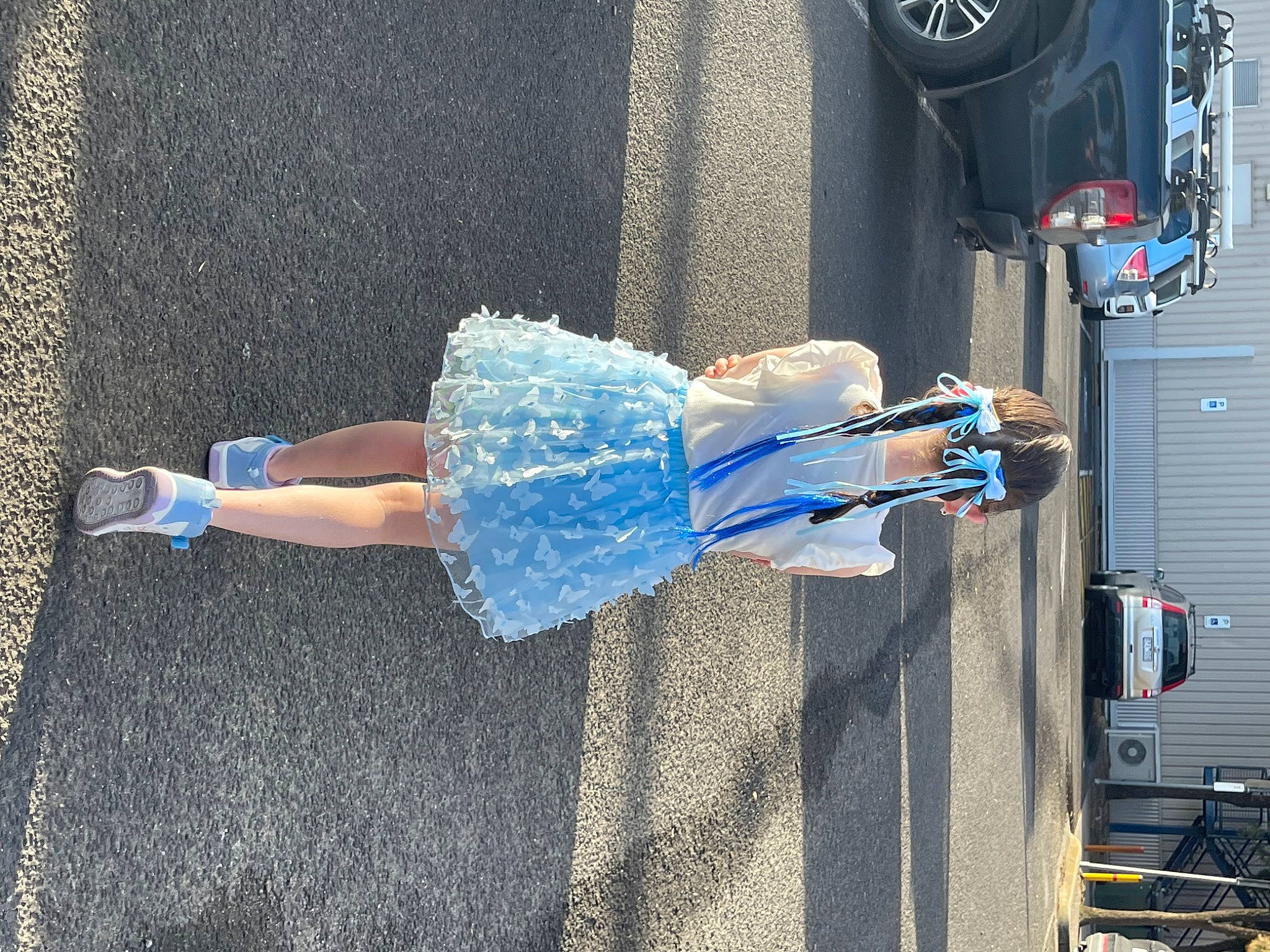 Pippa joined the competition — help win amazing prizes! asphalt, automotive_exterior, automotive_lighting, automotive_tire, azure, blue, car, denim, dress, electric_blue, human_leg, knee, leg, motor_vehicle, person, sidewalk, thigh, tire, vehicle_door, waist