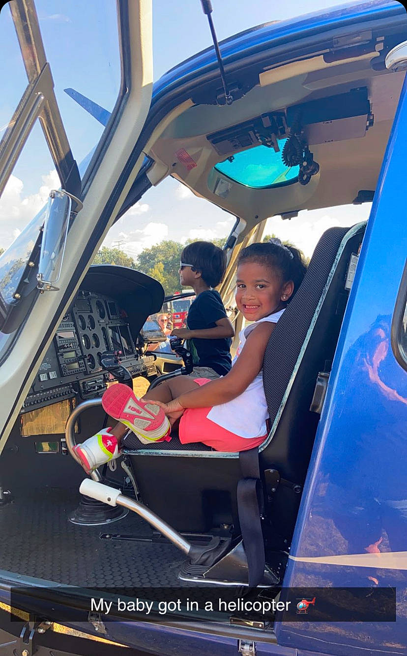 Khloe is registered to the contest to win money with this photo: air_travel, airline, auto_part, automotive_design, automotive_exterior, automotive_wheel_system, automotive_window_part, bumper, fun, hood, joy, leisure, mode_of_transport, motor_vehicle, person, recreation, sky, steering_wheel, toddler, travel