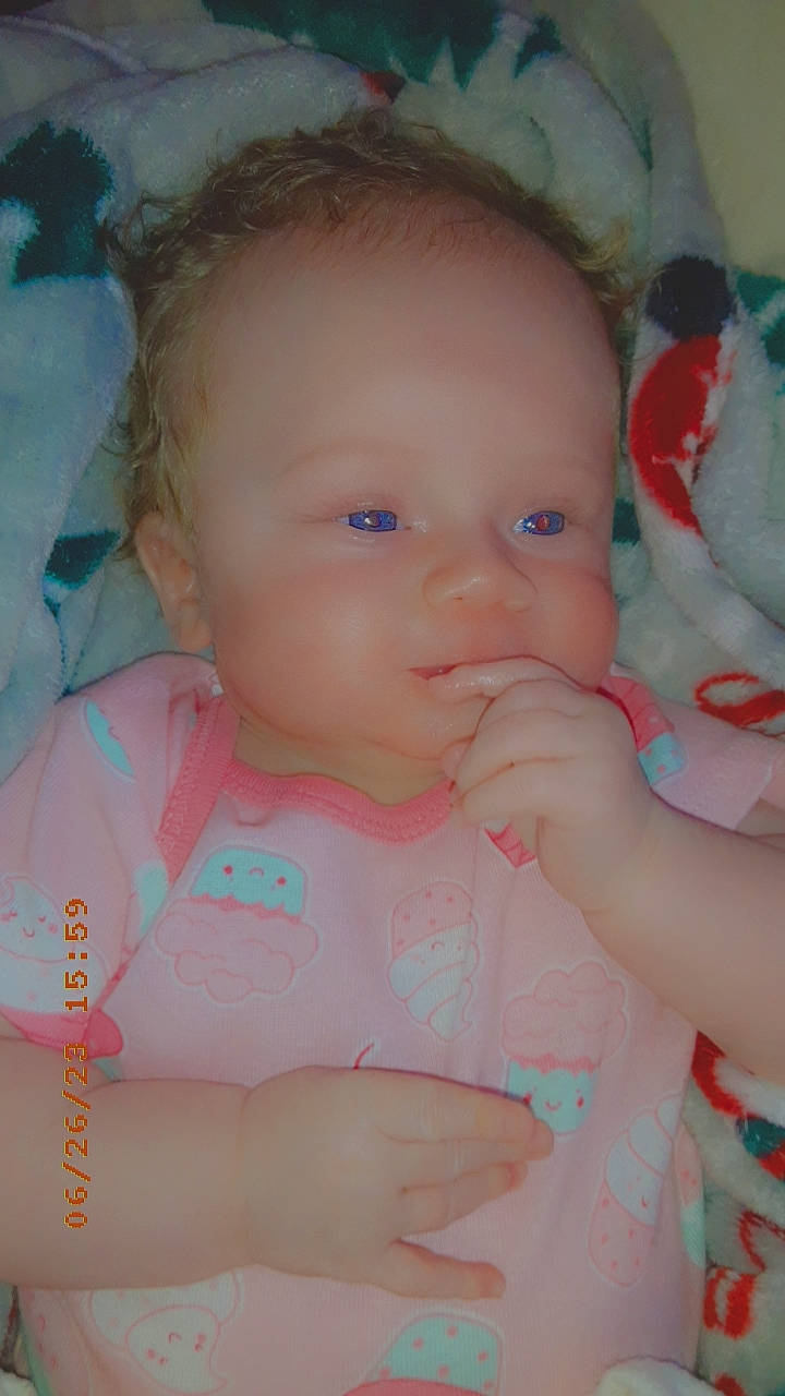 Mazie is registered to the contest to win money with this photo: baby, baby_toddler_clothing, cheek, chin, eye, face, facial_expression, hand, head, human_body, iris, lip, mouth, nose, person, pink, product, skin, sleeve, textile