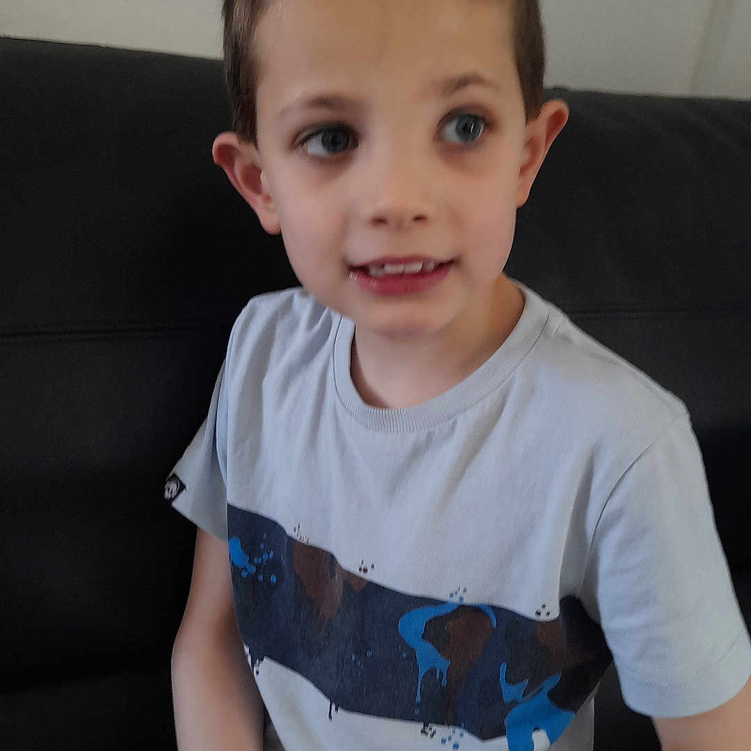 Hammond joined the competition — help win amazing prizes! bodypart, boy, child, clothing, couch, face, finger, furniture, hand, happy, head, longsleeve, male, person, photography, portrait, shorts, sitting, sleeve, t_shirt