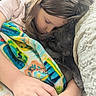 girl, cat, sleeping, blanket, cozy, indoor, child, pet, animal, resting, couch, comfort, closeup, casual, warm, relaxation, soft, cute, snuggle, together