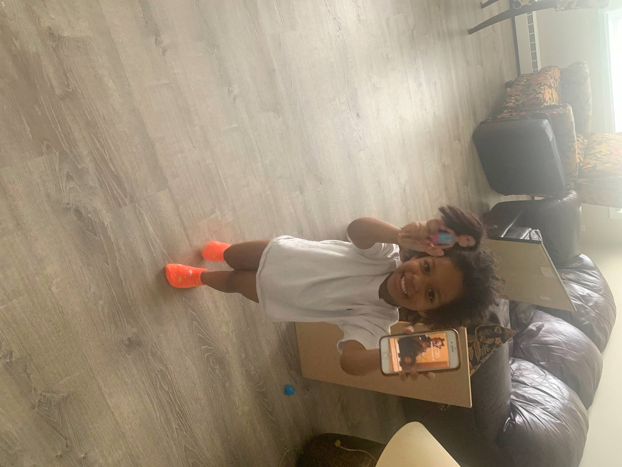 Karina is registered to the contest to win money with this photo: adventure, ceiling, comfort, elbow, floor, flooring, fun, hardwood, hat, human_leg, joy, knee, person, recreation, room, t_shirt, thigh, wood