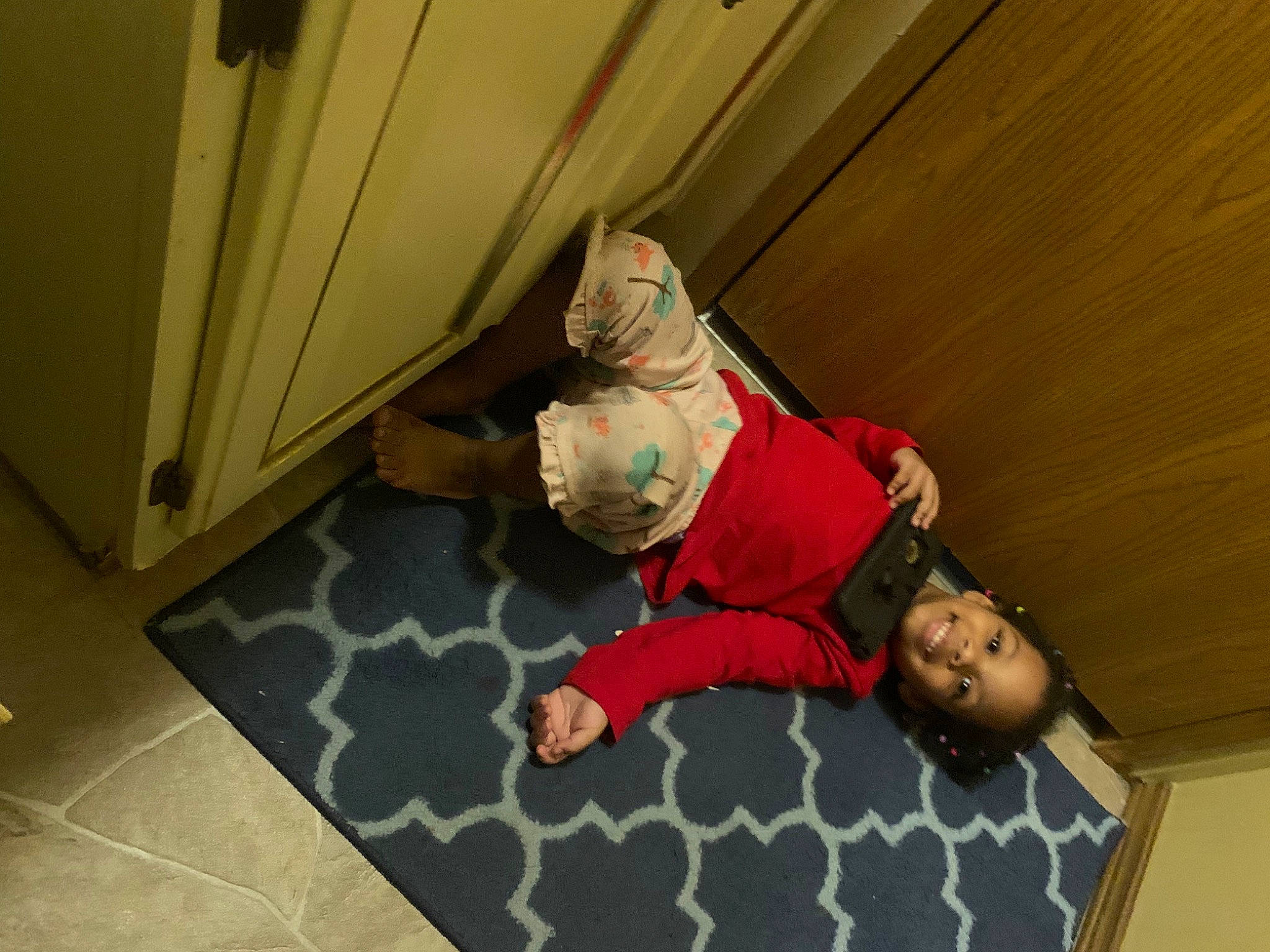 Karina is registered to the contest to win money with this photo: carpet, ceiling, child, comfort, flooring, fun, hardwood, joy, leisure, mammal, pattern, person, play, plywood, room, sitting, t_shirt, tile, toddler, wood