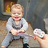 Luxxon joined the competition — help win amazing prizes! autumn_leaves, child, concrete, cute, flame_pattern, footwear, gray_clothing, hand, happy, interaction, outdoor, pacifier, person, play, playground, sitting, smiling, sneakers, toddler, toy