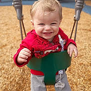 Luxxon joined the competition — help win amazing prizes! baby, child, clothing, daylight, equipment, face, fun, grey_pants, happy, joy, outdoor, pacifier, person, play, playground, red_jacket, smile, swing, toddler, wood_chips