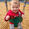 baby, child, clothing, daylight, equipment, face, fun, grey_pants, happy, joy, outdoor, pacifier, person, play, playground, red_jacket, smile, swing, toddler, wood_chips