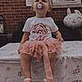 Oaklynn is registered to the contest to win money with this photo: toddler, child, pacifier, pink_tutu, shoes, table, tablecloth, brick_wall, window, balloon, bunny, outdoor, curious, sitting, face, cute, clothing, footwear, decor, party