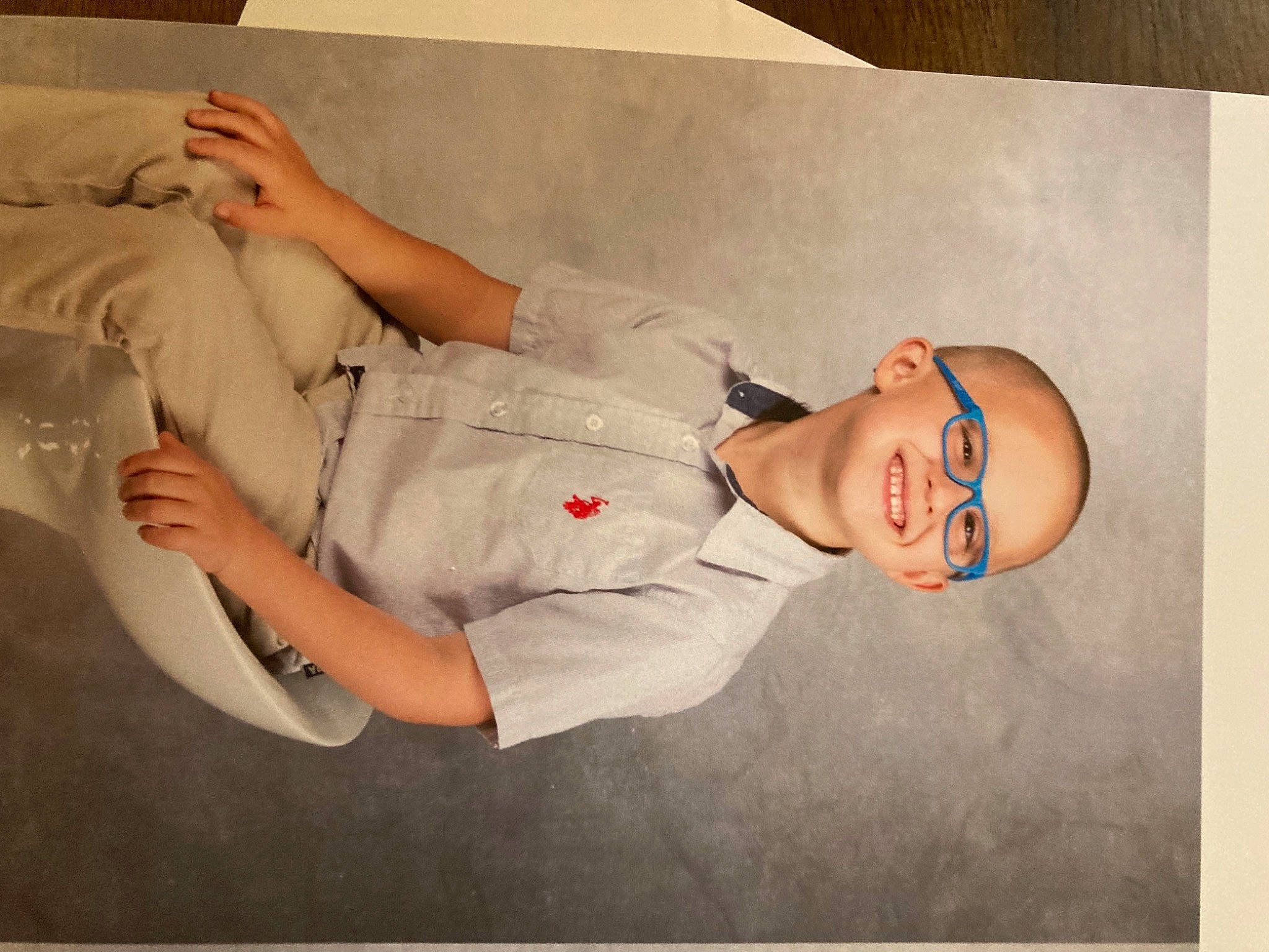 Kurtis is registered to the contest to win money with this photo: abdomen, art, child, comfort, elbow, eyewear, flesh, gesture, happy, human_leg, joy, knee, linens, paper, person, room, sleeve, smile, thigh, toddler