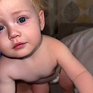 Amara-Rose joined the competition — help win amazing prizes! baby, child, infant, blue_eyes, blonde_hair, skin, face, curious, indoors, person, diaper, legs, arms, close_up, portrait, human, exploration, patterned_wallpaper, soft_light, candid