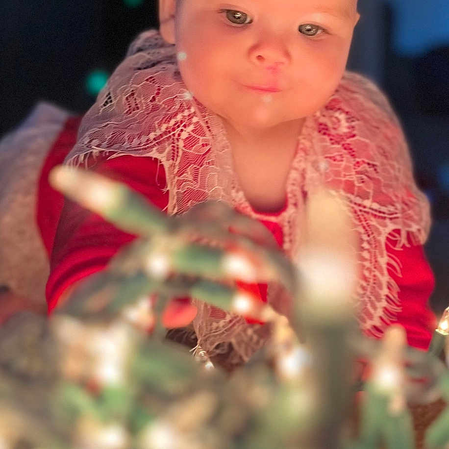 Kennedy is registered to the contest to win money with this photo: accessories, baby, candle, clothing, costume, dress, elf, face, flower, hat, head, lighting, nature, night, outdoors, person, photography, plant, portrait, toy