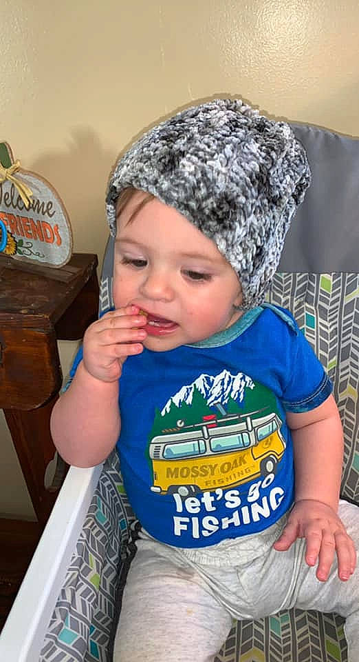 Kylar is registered to the contest to win money with this photo: baby, baby_toddler_clothing, cap, cheek, child, couch, electric_blue, eye, face, facial_expression, fun, happy, head, headgear, headwear, organ, person, sitting, skin, sleeve