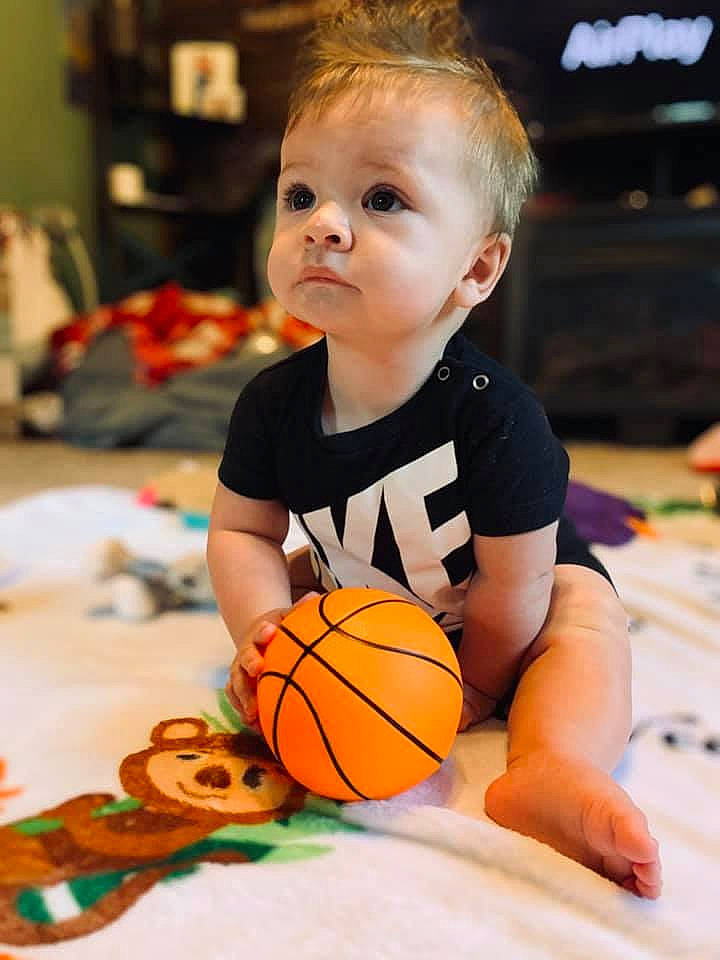 Kylar is registered to the contest to win money with this photo: baby, ball, ball_game, basketball, calabaza, child, eye, flooring, football, fun, happy, orange, person, player, room, snapshot, sports_equipment, sportswear, team_sport, toddler