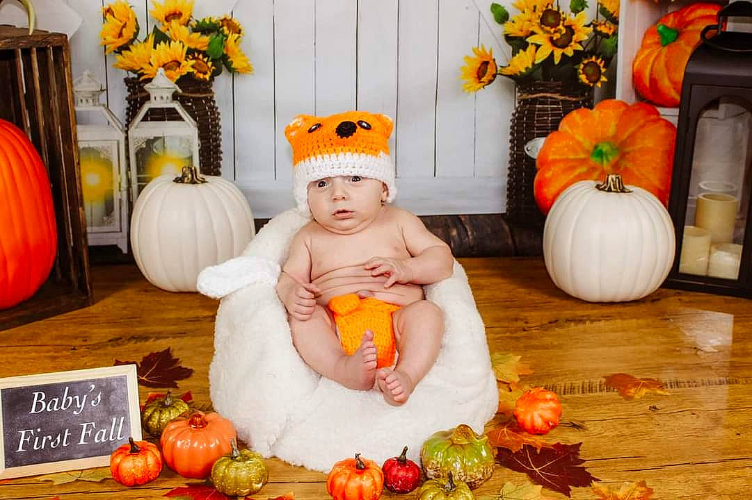 Dutton is registered to the contest to win money with this photo: baby, calabaza, child, cucurbita, food, gourd, grass, headwear, local_food, natural_foods, orange, person, photograph, plant, pumpkin, squash, toddler, vegetable, whole_food, winter_squash