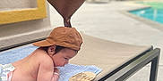 Paulo joined the competition — help win amazing prizes! baby, infant, cap, balloon, heart_shaped, towel, lounge_chair, poolside, outdoor, milestone, wooden_sign, three_months, cute, child, skin, diaper, relaxing, sunny, daytime, focus