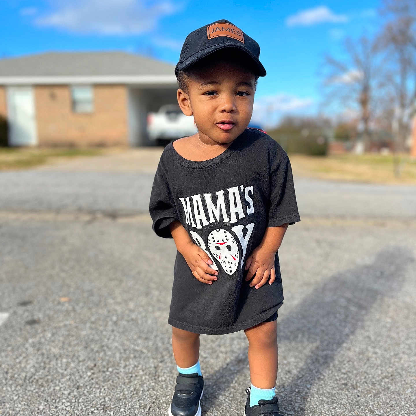 Tobias is registered to the contest to win money with this photo: baseballcap, boy, cap, child, clothing, face, footwear, hat, head, male, pants, person, photography, portrait, shoe, shorts, sitting, sleeve, standing, t_shirt