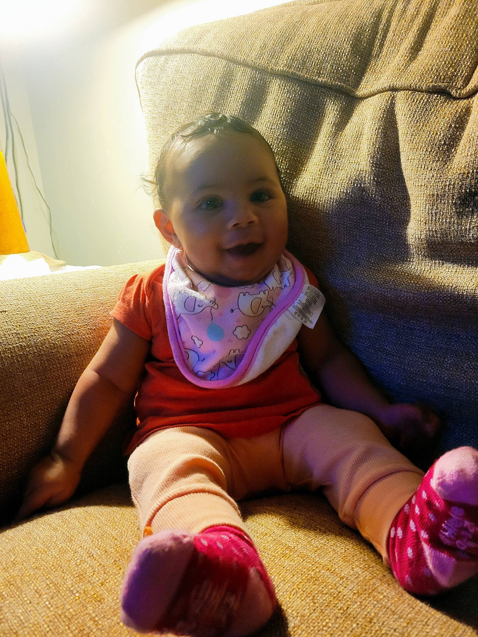 Jaelynn is registered to the contest to win money with this photo: baby, baby_toddler_clothing, cheek, comfort, face, finger, floor, flooring, fun, hairstyle, happy, iris, magenta, person, pink, purple, skin, sleeve, smile, sock