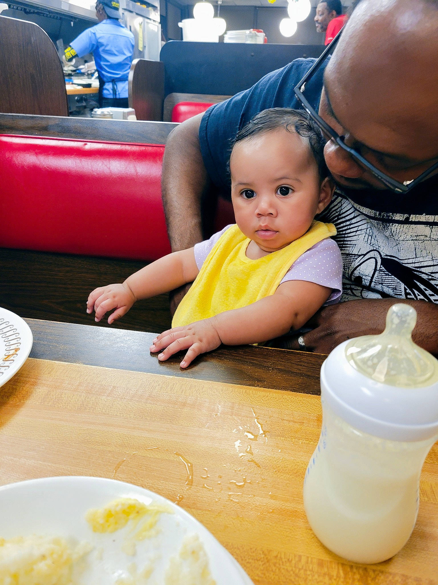 Jaelynn joined the competition — help win amazing prizes! baby, chair, child, comfort_food, cuisine, desk, dishware, drinkware, eyewear, food, fun, glasses, person, plastic_bottle, plate, sharing, t_shirt, table, tableware, toddler