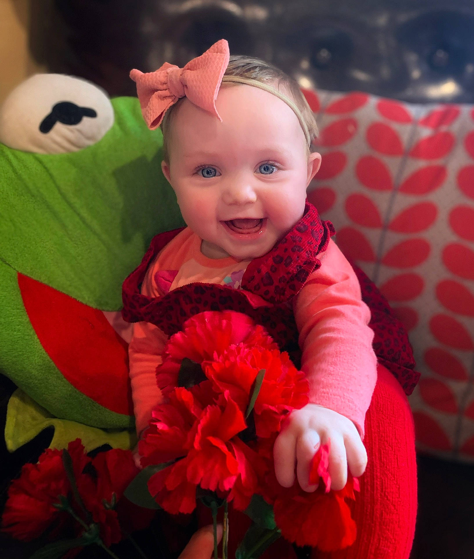 Cassidy is registered to the contest to win money with this photo: baby, baby_toddler_clothing, beauty, couch, eye, flower, grass, happy, head, human_body, magenta, person, petal, pink, plant, skin, smile, stuffed_toy, textile, toddler
