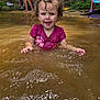 toddler, child, water, splashing, curly_hair, playful, outdoor, nature, forest, adults, relaxing, summer, muddy_water, toy, pink_shirt, person, recreation, happy, daytime, lake
