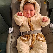 Léo participe au concours pour gagner de l'argent avec cette photo : baby, infant, smiling, fluffy_clothing, onesie, bear_ears, baby_seat, cushioned_seat, cute, happy, indoor, child, face, hands, warm_clothing, plush, adorable, seated, cozy, sleepwear