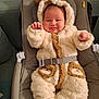baby, infant, smiling, fluffy_clothing, onesie, bear_ears, baby_seat, cushioned_seat, cute, happy, indoor, child, face, hands, warm_clothing, plush, adorable, seated, cozy, sleepwear